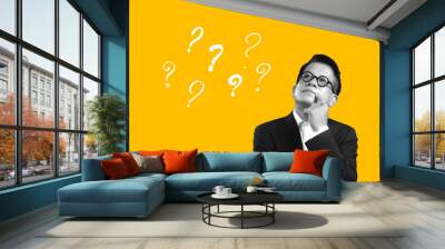 Asian businessman thinking something with question marks on yellow background. Inspiration trendy idea concept, modern design, contemporary art collage. Wall mural