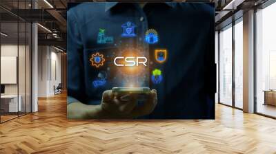 CSR concept for business and organization. Corporate social responsibility and giving back to the community. Businessman showing neon line banner of CSR icons concept on virtual screen. Wall mural