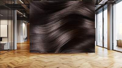 A closeup view of a bunch of shiny curls brown hair Wall mural