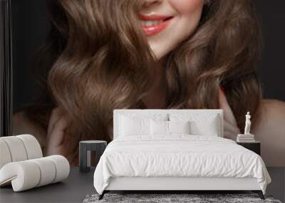 Beautiful brown-haired girl with a perfectly curls hair, and classic make-up. Beauty face. Wall mural