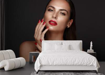 Beautiful girl with a classic make-up and red nails. Manicure design. Beauty face. Wall mural