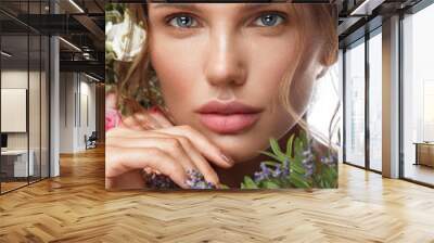 Beautiful woman with classic nude make-up, light hairstyle and flowers. Beauty face. Wall mural