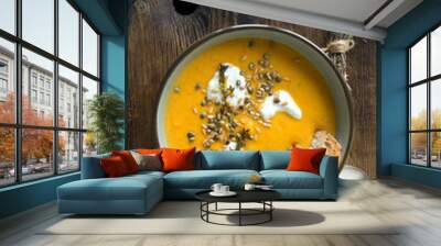 bowl with traditional French carrot cream soup on the table Wall mural