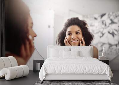 Woman, skincare and dermatology in mirror with a smile in the bathroom for wellness at a hotel. Model, happy and beauty with skin, glow for self care in the morning at an apartment for healthy face. Wall mural