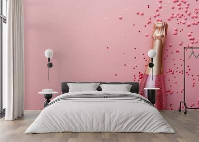 pink champagne bottle with excited cork popping surrounded by confetti on a pink background, symboli Wall mural