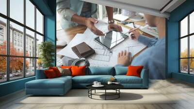 Architects and interior designers women discussing to concept of building design. Estimation for construction project with tablet technology, Drawing, Material and Model. Selective focus center image Wall mural