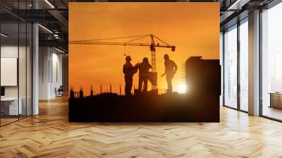 Silhouette engineer construction work control and tower crane background on natural sunset sky.,Heavy industry and building construction work concept in banner Wall mural