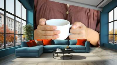 Hot coffee cup in woman hand. Wall mural