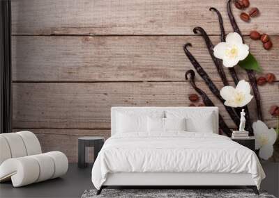 vanilla sticks with coffee beans avd flower on a old wooden background with copy space for your text Wall mural