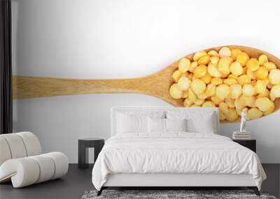 yellow split peas in a wooden spoon isolated on white background. Top view Wall mural