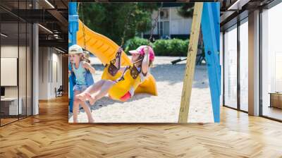 Children swinging on a swing Wall mural