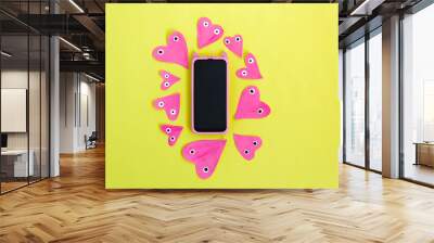 Hand made for Valentines or Mothers day. Hand painted pink paper hearts on a yellow background. Flat lay. Creative mock up with smartphone. Wall mural