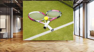 Close-up of two tennis rackets with a tennis ball Wall mural