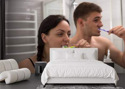 Close-up young couple brushing their teeth Wall mural