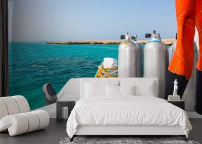 Oxygen tanks on the deck of the yacht near diving suit Wall mural