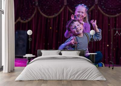 Two funny children acting as monsters on stage Wall mural