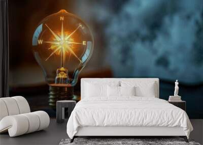 A light bulb with a compass inside, denoting navigation and direction in ideation Wall mural