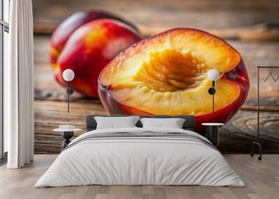 A close-up of a bitten nectarine, with the juicy interior glistening under natural light, set on a rustic wooden table. Wall mural