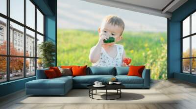 the child greedily eating cucumber Wall mural