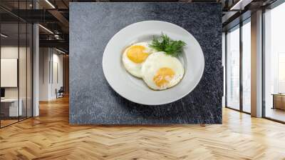 Two eggs with a yellow yolk on a white plate Wall mural