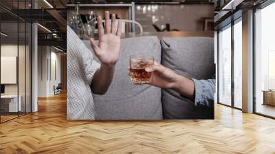 Close up hand rejecting glass of whiskey and alcohol, alcoholic and quit concept. Wall mural