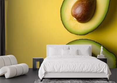 Avocado Delight: A vibrant, minimalistic still life featuring two halved avocados against a sunny yellow background. The fresh green flesh and brown pits create a visually appealing contrast. Wall mural