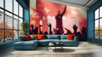 Silhouette of a singer on a stage singing to the crowd with the hands raised up Wall mural