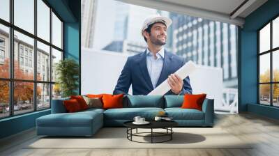 Man engineer standing on construction site. Engineer working on outdoor project Wall mural