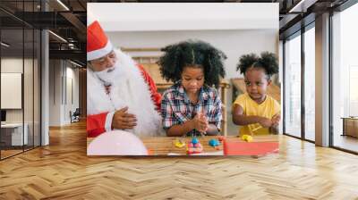 two African little child girl playing together at home , Two African brother and sister play some toys together in the room with day light with main focus on little girl. Wall mural