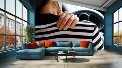 Close up woman having pain on neck and shoulder while driving car. Long driving on the way.. Wall mural