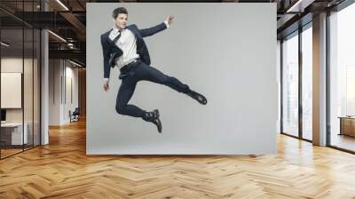 Attractive young man in fancy pose Wall mural