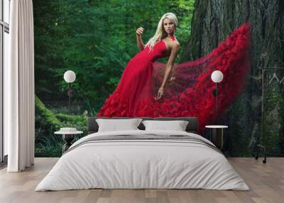 Beautiful woman wearing an amazing red gown Wall mural