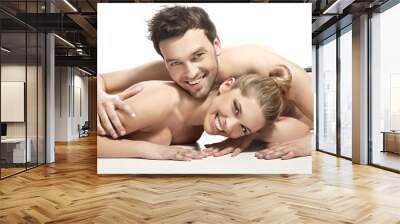 Beautiful young couple lying on the bed Wall mural