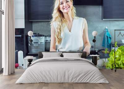 Cheerful blonde making a helathy lunch Wall mural