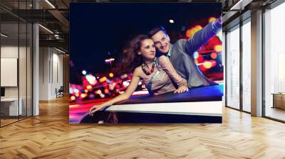 Elegant couple traveling a limousine at night Wall mural