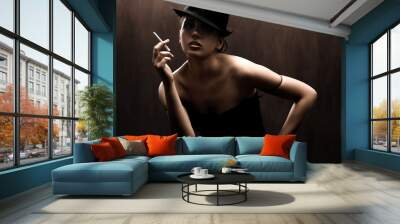 fashion style photo of a gorgeous brunette holding a cigarette Wall mural