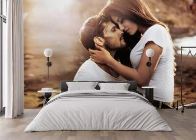 Handsome man hugging his sensual girlfriend Wall mural