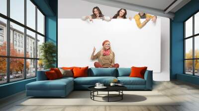 Pleased group of friends enjoying their company Wall mural