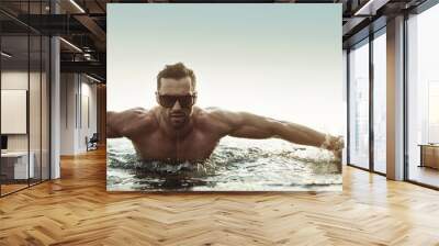 Portrait of a serious man in a tropical pool Wall mural