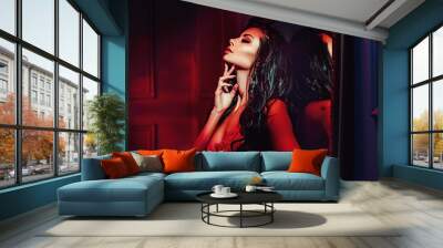 Seductive brunette woman in the red place Wall mural