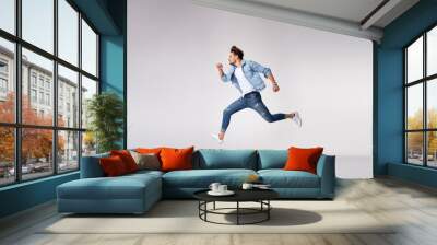 Stylish, handsome man running - isolated Wall mural