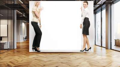 two businesswomen carrying a white board Wall mural