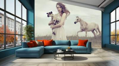 Young brunette lady holding little lamb Wall mural