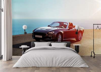 Young couple riding a luxurious convertible Wall mural