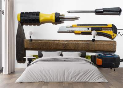 Hammer, screwdriver, construction knives and measuring tape isolated. Top view on construction tools. Flat lay composition with DIY home tools. construction and repair tools. Labor day concept Wall mural