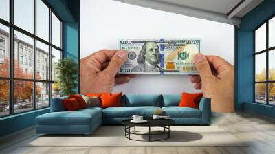 Man's hands holding one hundred dollar bill Wall mural