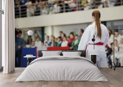 Sports kids - teenager girl sportsmen on karate at tatami arena - ready for fight Wall mural