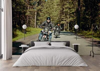 Two bikers are on their bikes riding too fast on the road Wall mural