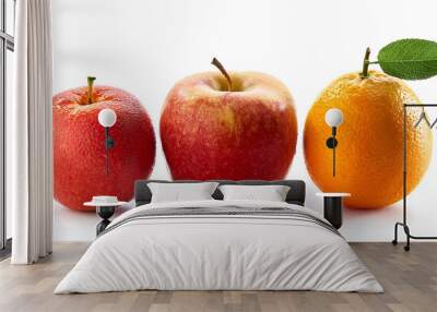 Close-up of two apples and one orange arranged side by side against a white background, emphasizing freshness and vibrant colors of the fruits. Wall mural