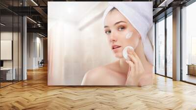 applying cosmetic cream Wall mural